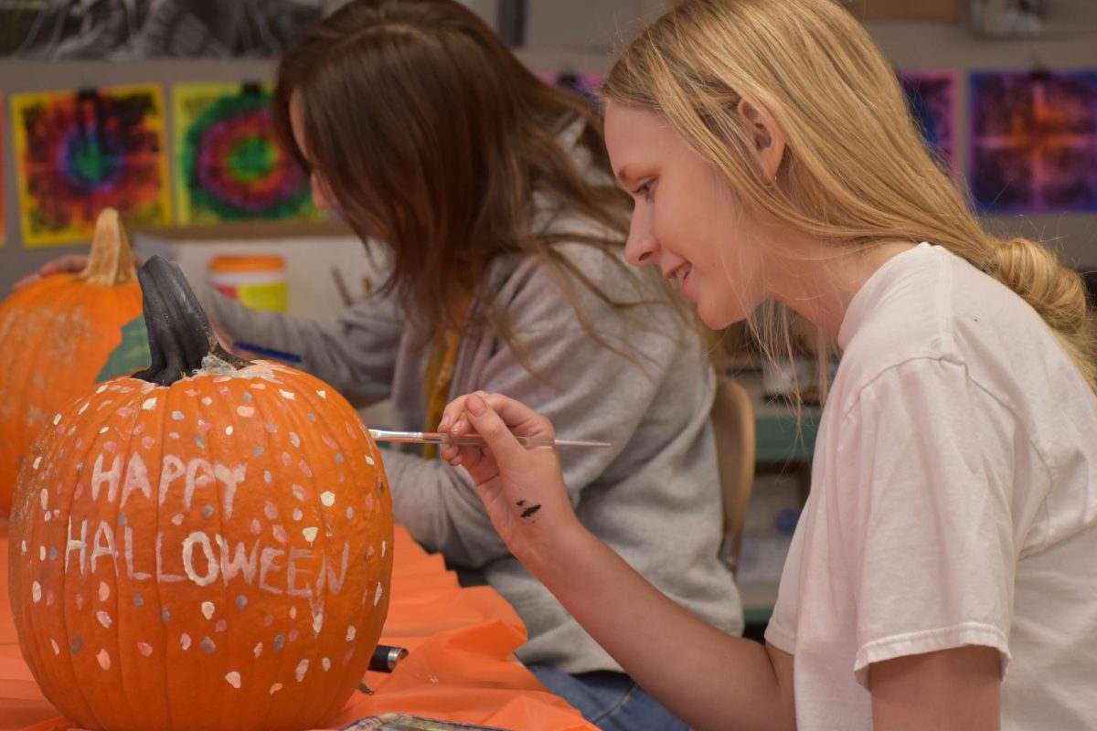 Students participating in pumpkin painting pizza party a few years prior. 