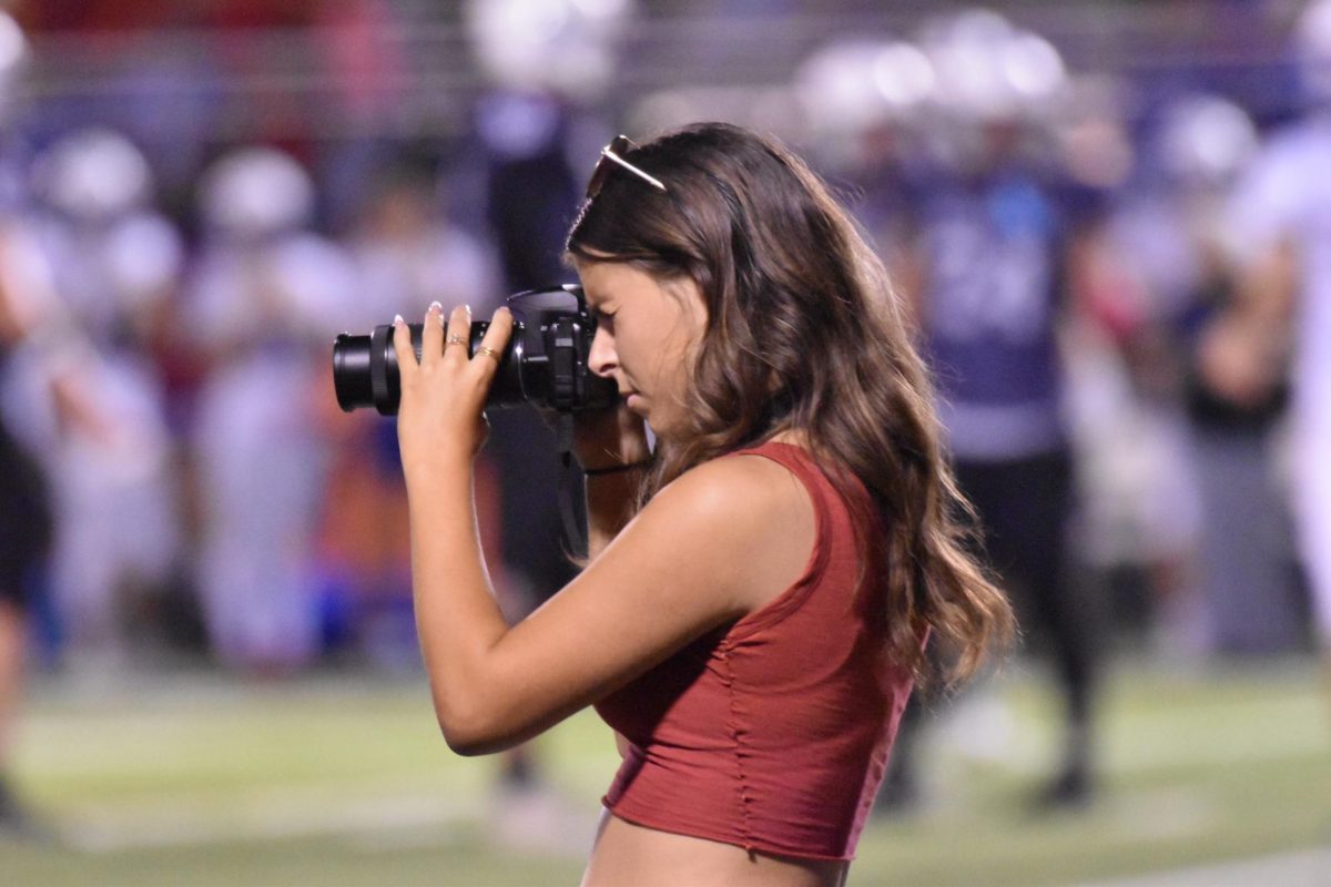 Yearbook photographers, such as Rylee Holder, are taking pictures at many BHS events.