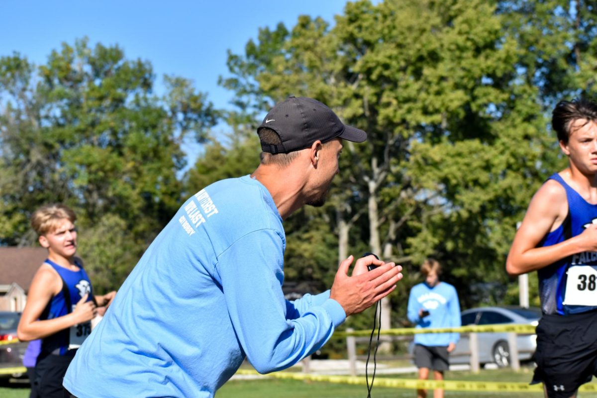 Coach Broxterman cheering on his runners.